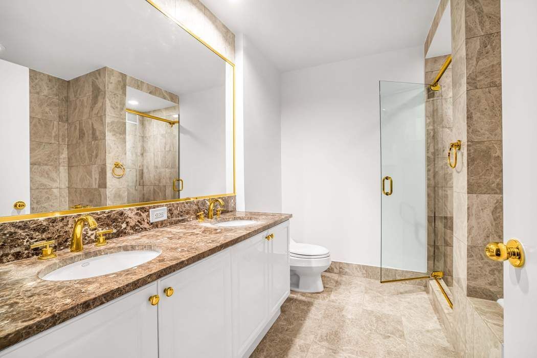 220 Riverside Boulevard, Unit 5L Manhattan, NY 10069 - Photo 7 of 16 a bathroom with a granite countertop sink and a mirror