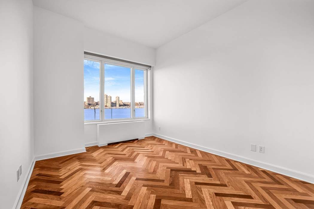 220 Riverside Boulevard, Unit 5L Manhattan, NY 10069 - Photo 8 of 16 a bedroom with a bed and a window