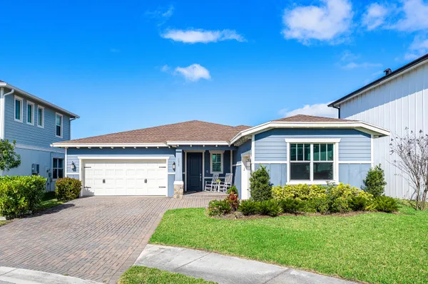 a view of a house with a yard and plants