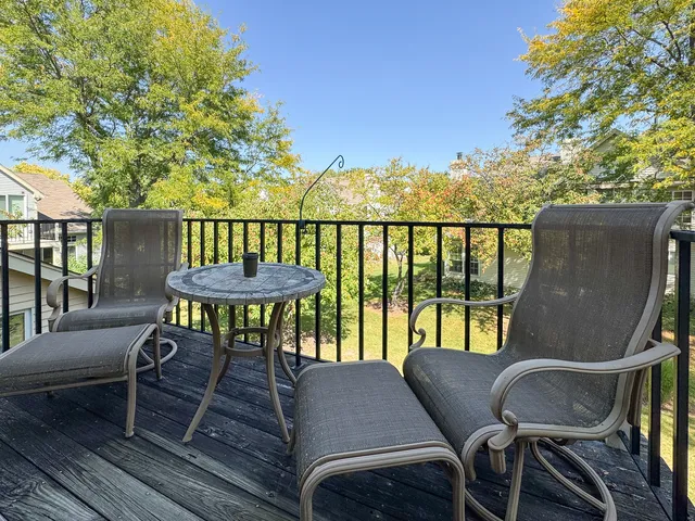 a balcony view with a seating space