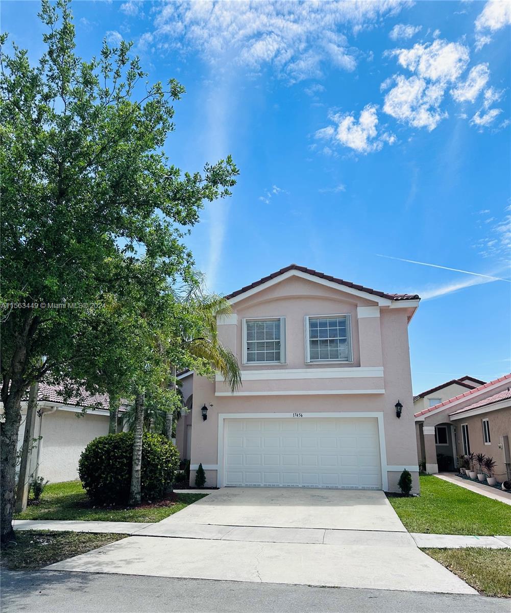 17456 Southwest 20th Street Miramar, FL 33029 - Photo 1 of 34 a front view of a house with a yard