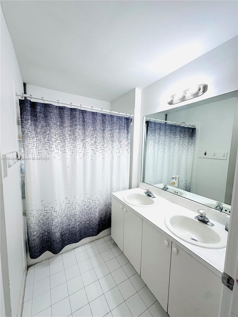 17456 Southwest 20th Street Miramar, FL 33029 - Photo 18 of 34 a bathroom with a sink a toilet and mirror