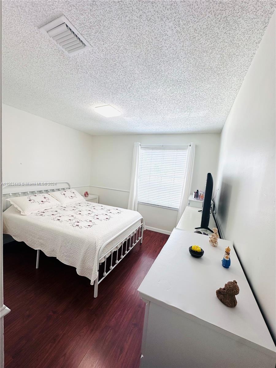 17456 Southwest 20th Street Miramar, FL 33029 - Photo 19 of 34 a bedroom with a bed and a table