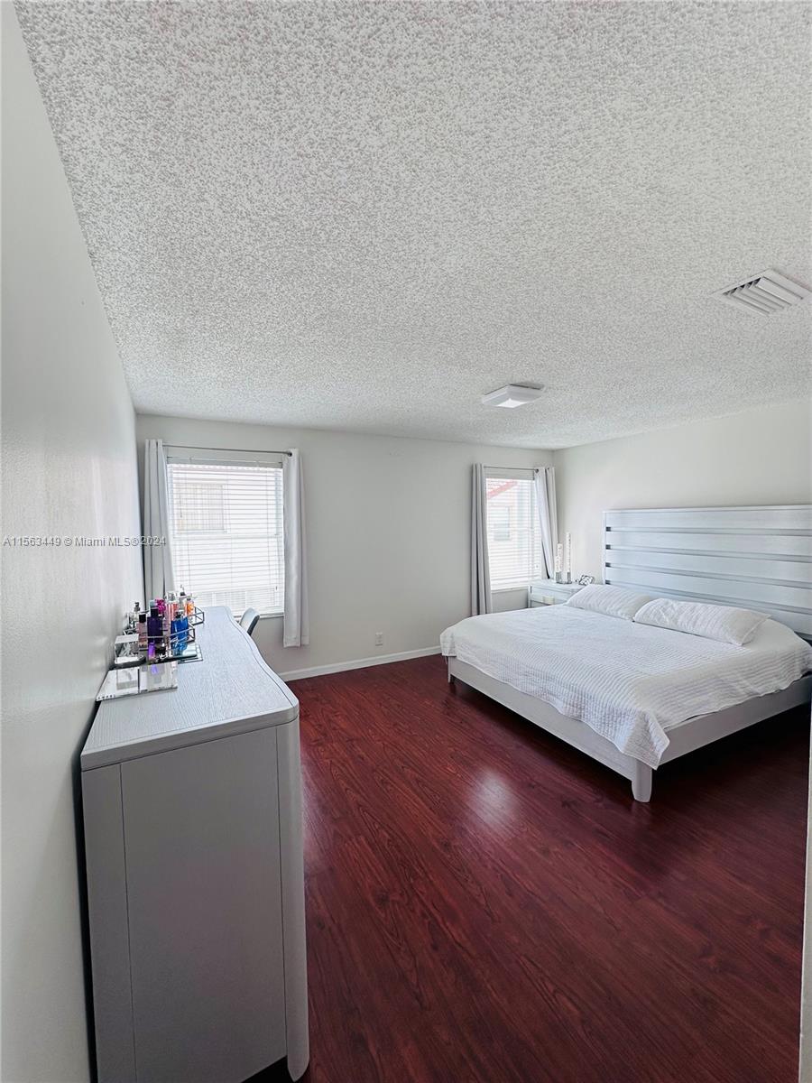 17456 Southwest 20th Street Miramar, FL 33029 - Photo 23 of 34 a bedroom with a bed and wooden floor