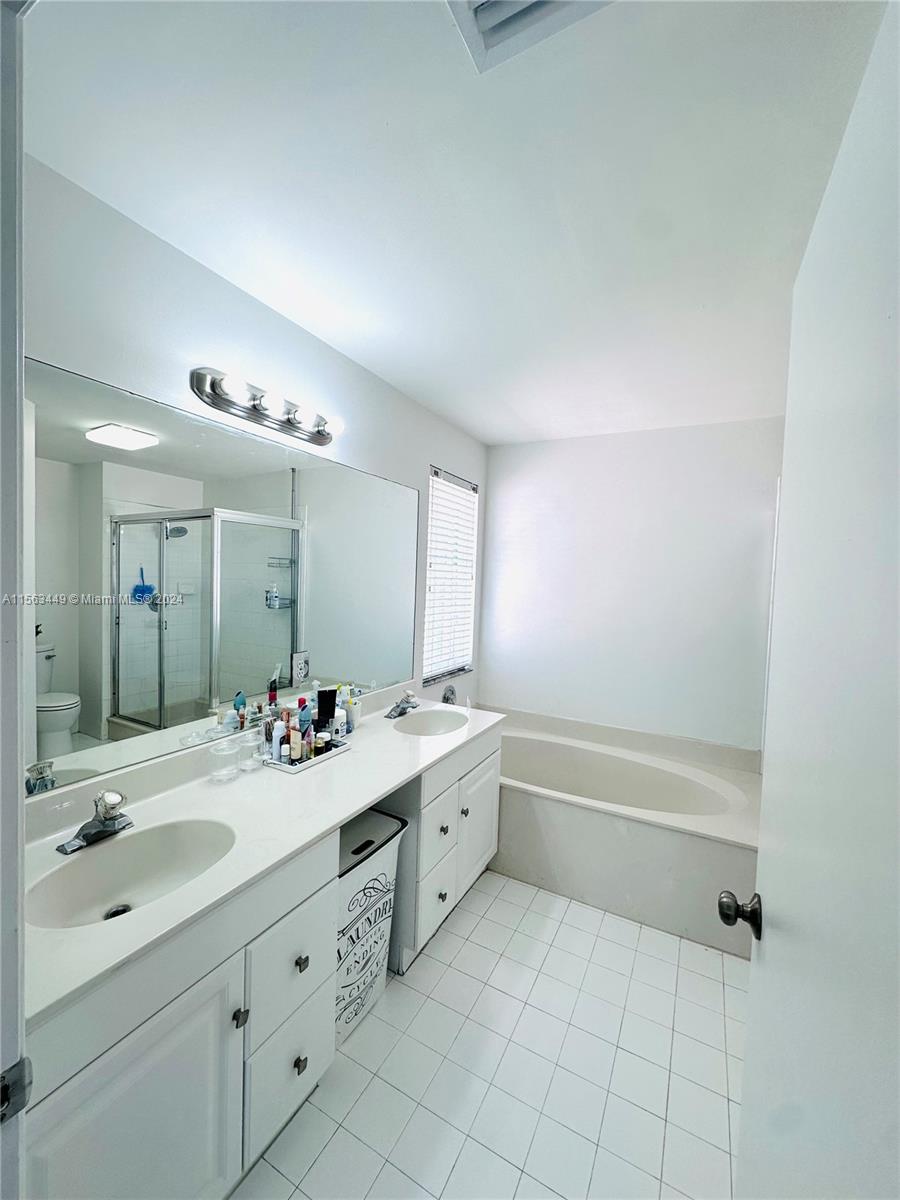 17456 Southwest 20th Street Miramar, FL 33029 - Photo 26 of 34 a spacious bathroom with a double vanity sink mirror and bathtub
