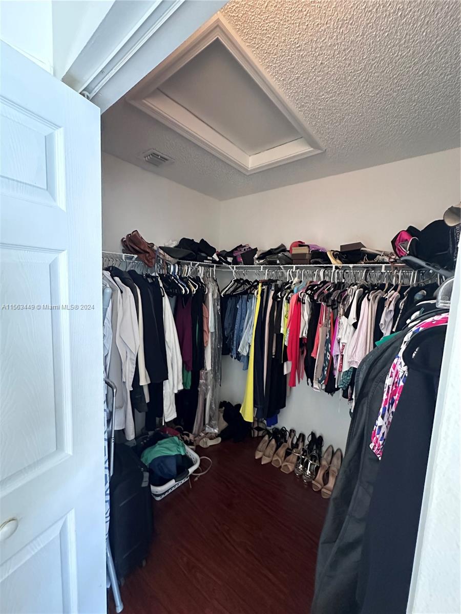 17456 Southwest 20th Street Miramar, FL 33029 - Photo 27 of 34 a view of walk in closet with clothes and shoes