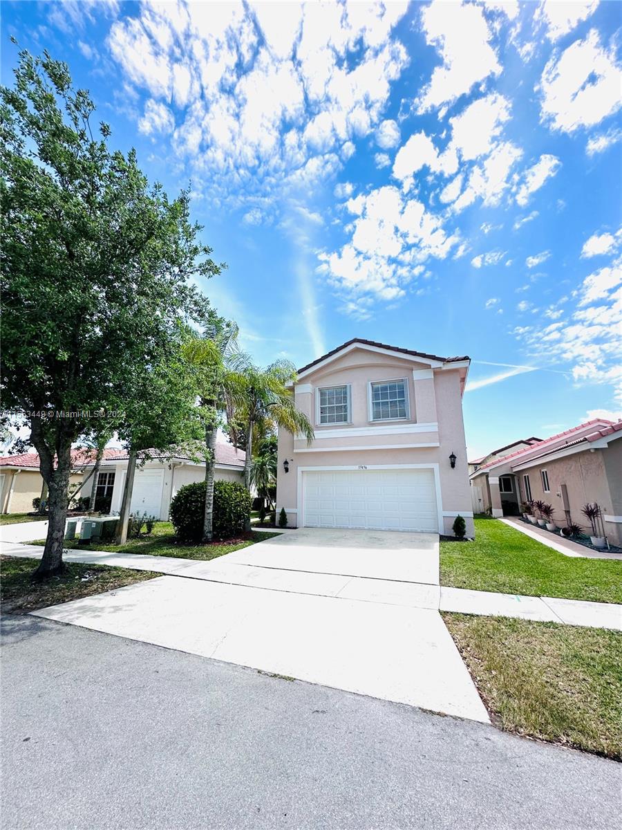17456 Southwest 20th Street Miramar, FL 33029 - Photo 3 of 34 a front view of a house with a yard garage and outdoor seating