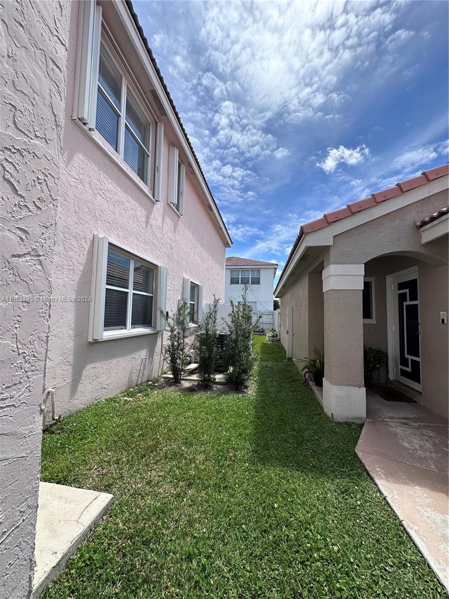 17456 Southwest 20th Street Miramar, FL 33029 - Photo 31 of 34 a view of a house with a yard and pathway