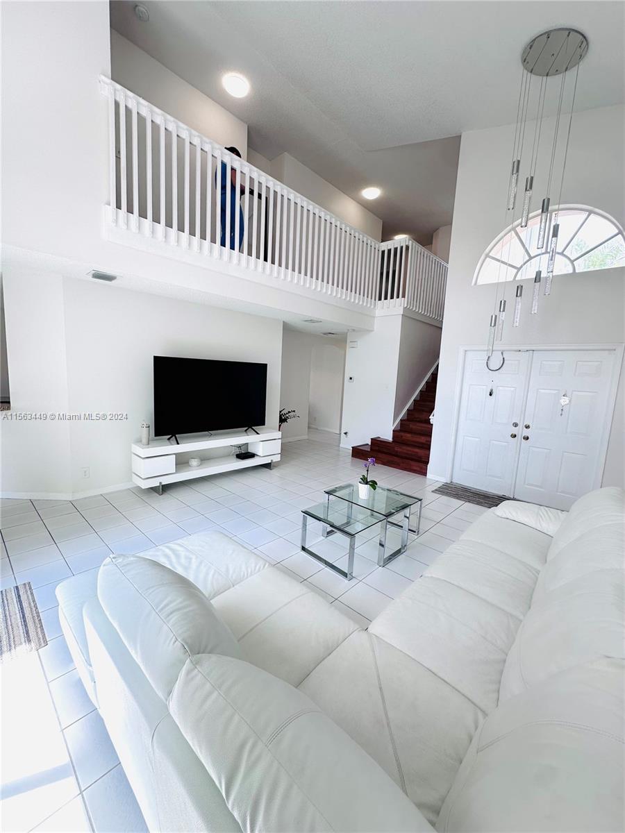 17456 Southwest 20th Street Miramar, FL 33029 - Photo 5 of 34 a living room with furniture and a flat screen tv