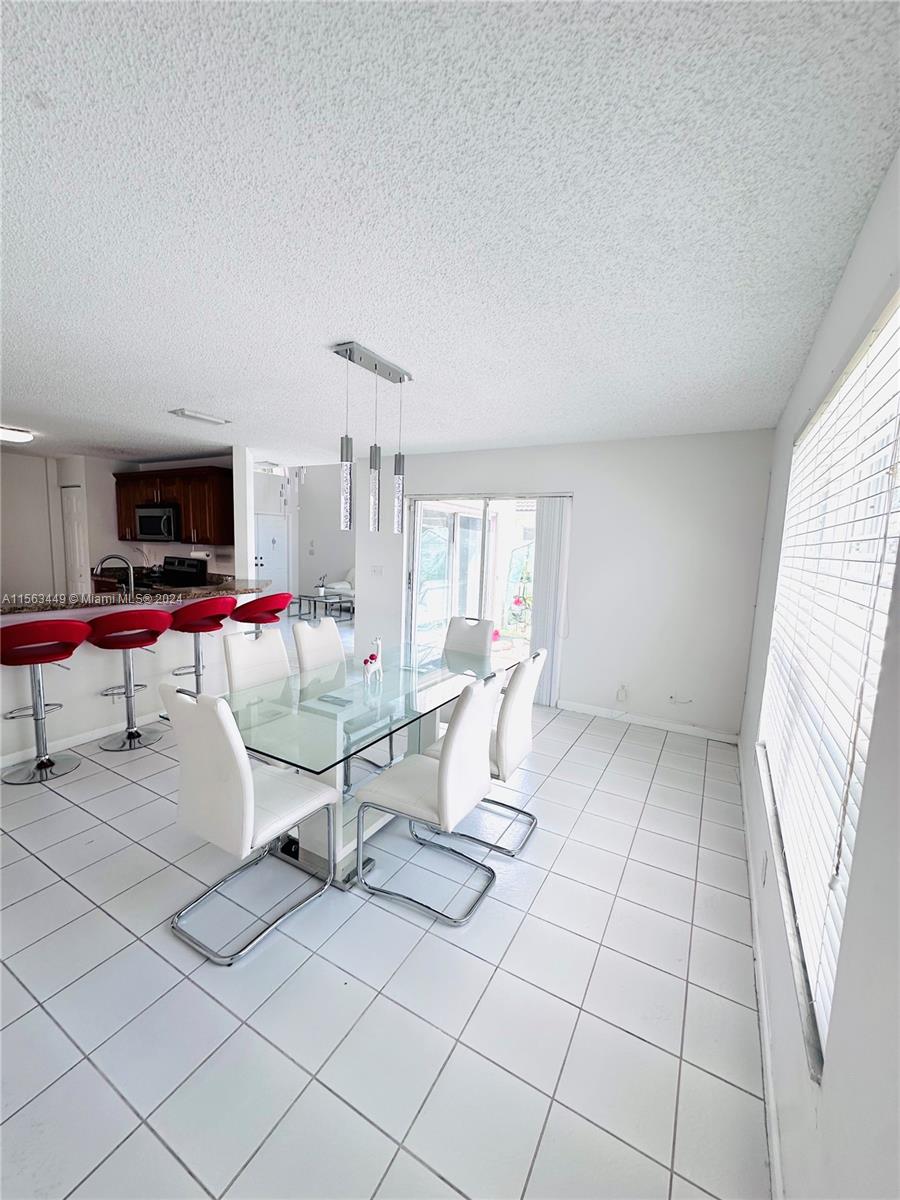 17456 Southwest 20th Street Miramar, FL 33029 - Photo 7 of 34 a living room with furniture and white walls