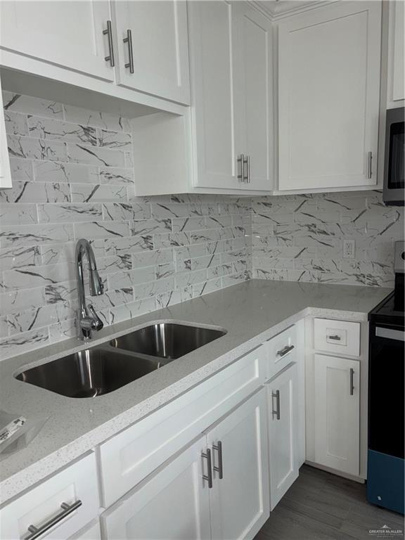 3056 Stark Road, Unit 2 Weslaco, TX 78596 - Photo 15 of 17 a view with granite countertop white cabinets sink and dishwasher