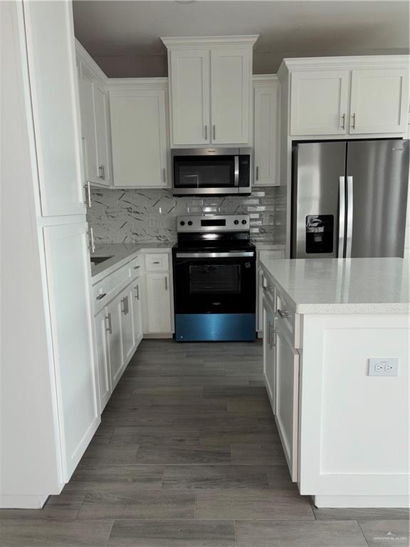 3056 Stark Road, Unit 2 Weslaco, TX 78596 - Photo 3 of 17 a kitchen with stainless steel appliances granite countertop a refrigerator a stove a sink and a microwave