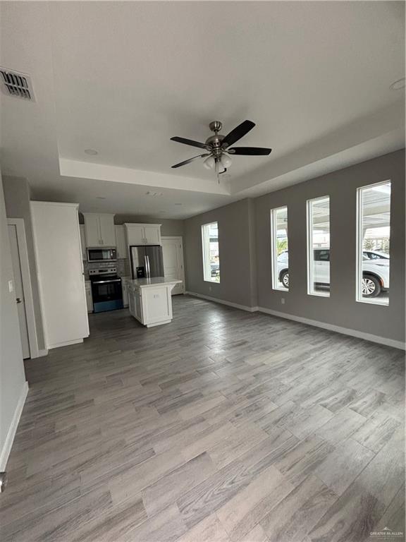 3056 Stark Road, Unit 2 Weslaco, TX 78596 - Photo 4 of 17 a view of an empty room with a window and wooden floor