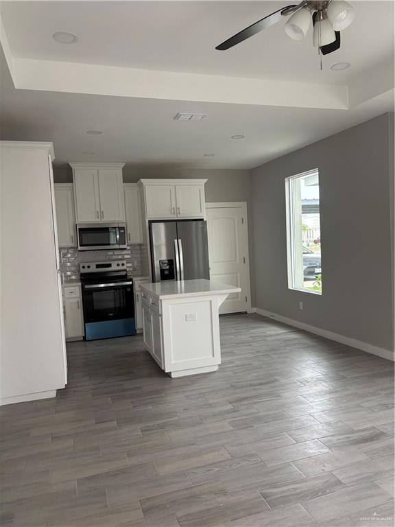 3056 Stark Road, Unit 2 Weslaco, TX 78596 - Photo 5 of 17 a kitchen with granite countertop a stove and a refrigerator