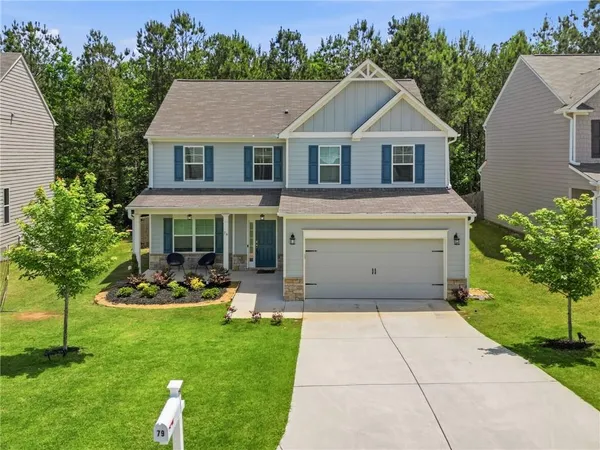 a front view of a house with garden