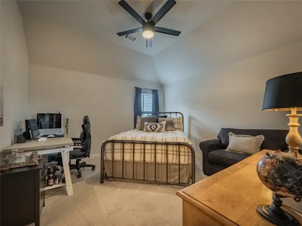 a living room with furniture a flat screen tv and large windows