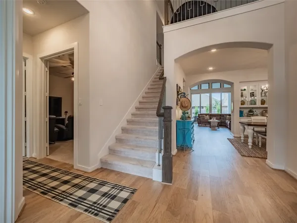 a view of a hallway view with wooden floor and staircase