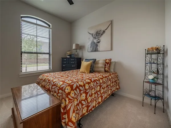 a bedroom with bed and window