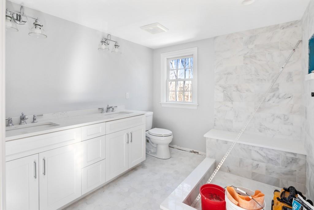 52 Union Street Hingham, MA 02043 - Photo 12 of 21 a spacious bathroom with a granite countertop sink a toilet and shower