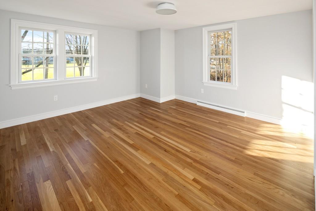 52 Union Street Hingham, MA 02043 - Photo 14 of 21 a view of an empty room with wooden floor and a window