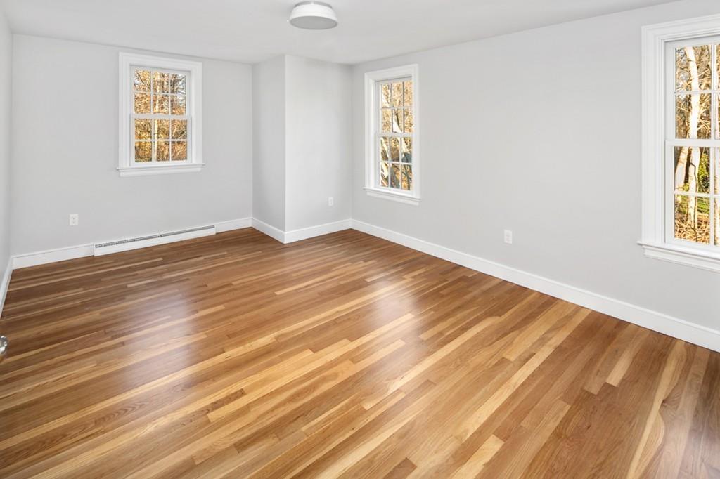 52 Union Street Hingham, MA 02043 - Photo 16 of 21 a view of an empty room with wooden floor and a window