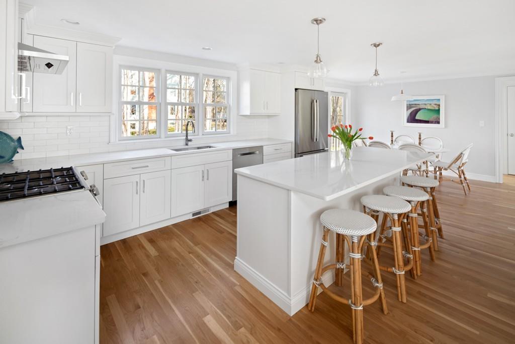 52 Union Street Hingham, MA 02043 - Photo 3 of 21 a kitchen with white cabinets and wooden floor