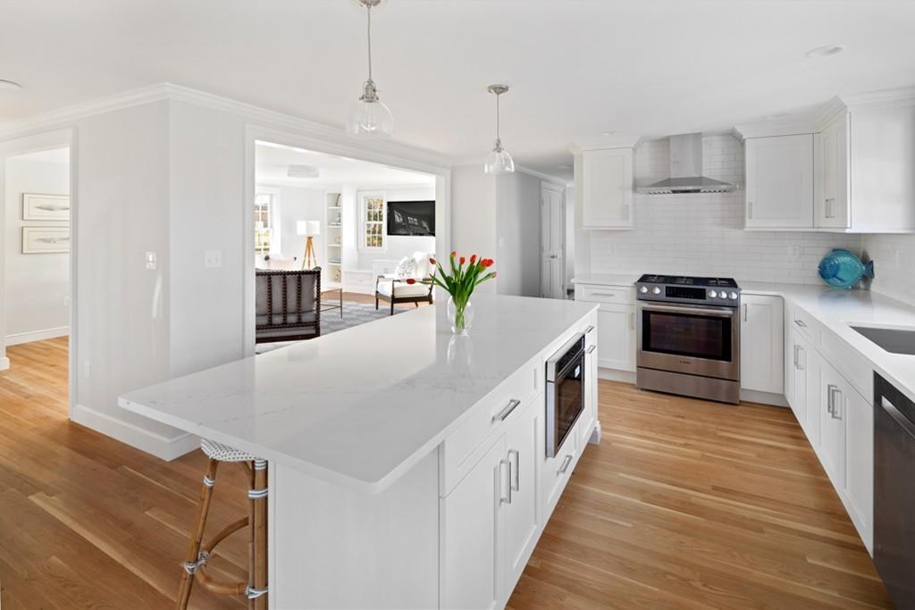 52 Union Street Hingham, MA 02043 - Photo 4 of 21 a kitchen with stainless steel appliances a sink a stove top oven a counter space and cabinets