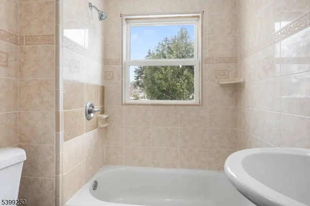 a bath tub sitting next to a white toilet