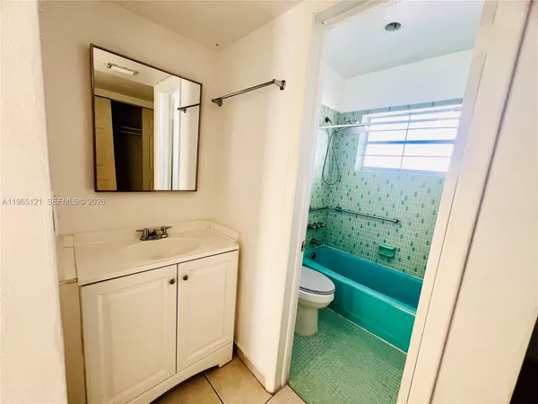 a bathroom with a sink a toilet and a shower