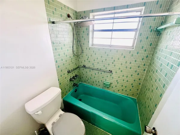 a bathroom with a toilet and a bathtub