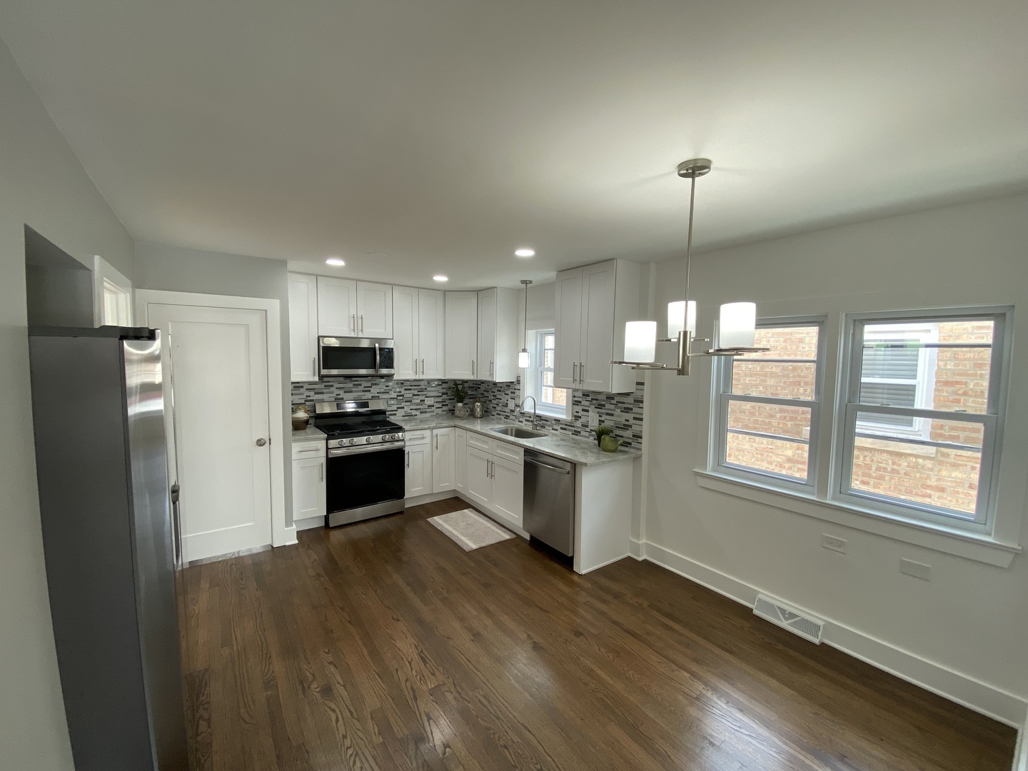 6531 West 64th Street Chicago, IL 60638 - Photo 3 of 19 a kitchen with a refrigerator and white cabinets