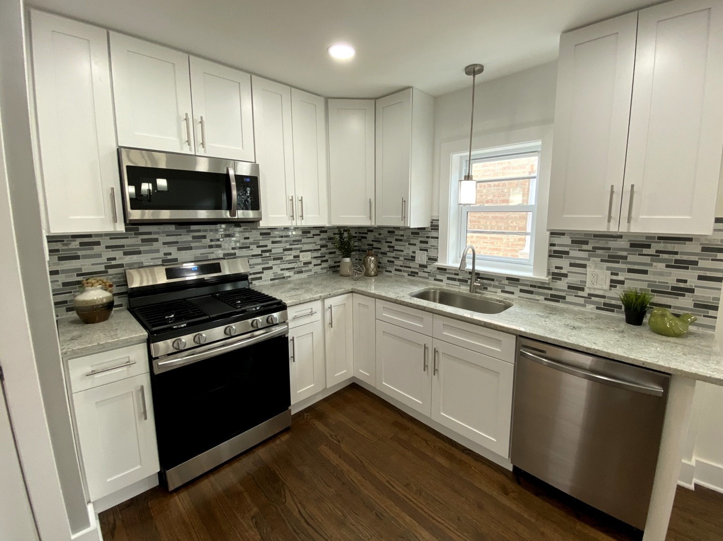 6531 West 64th Street Chicago, IL 60638 - Photo 4 of 19 a kitchen with granite countertop a sink cabinets and stainless steel appliances