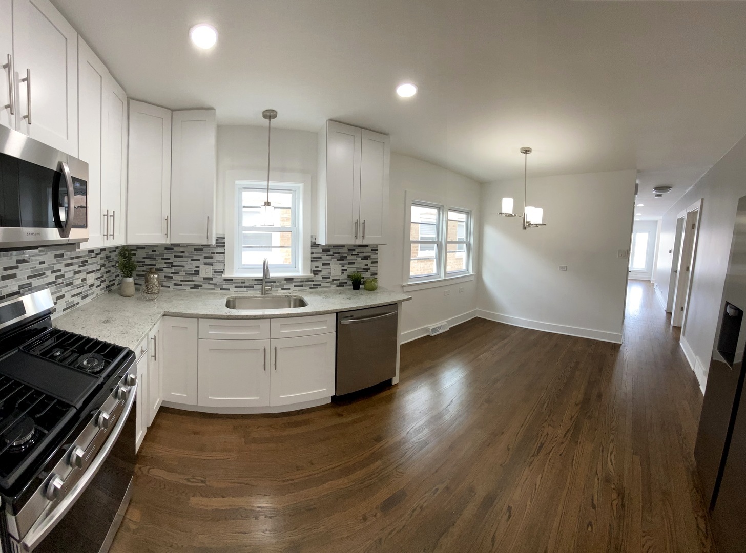 6531 West 64th Street Chicago, IL 60638 - Photo 5 of 19 a kitchen with stainless steel appliances kitchen island granite countertop a stove a sink and white cabinets with wooden floor