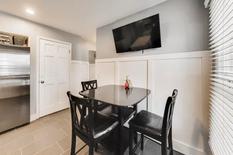 a view of a dining room with furniture and a window