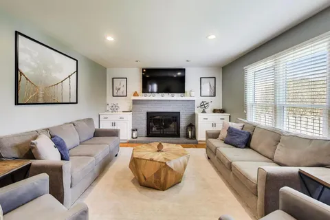 a living room with furniture fireplace and window
