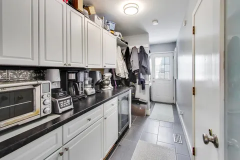 a kitchen with stainless steel appliances granite countertop a refrigerator and a stove