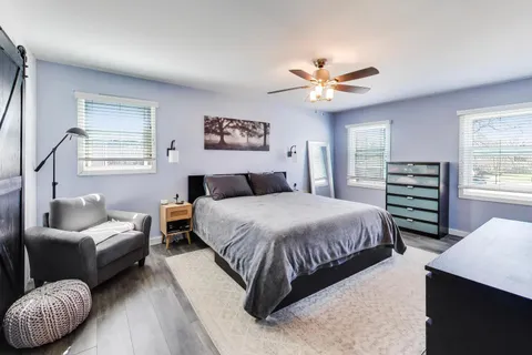 a bedroom with a bed and a couch