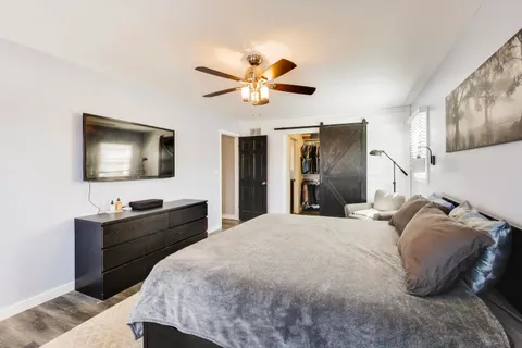 a bedroom with a bed and a flat screen tv
