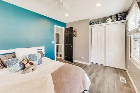 a bed room with a bed and a refrigerator