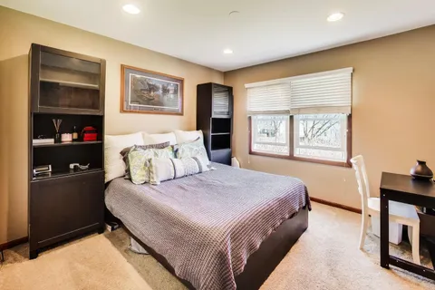 a bedroom with a large bed and a window