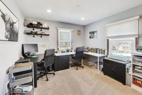 a view of a workspace with a window and lounge chair