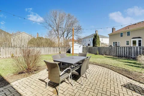 a view of a patio with a table and chairs