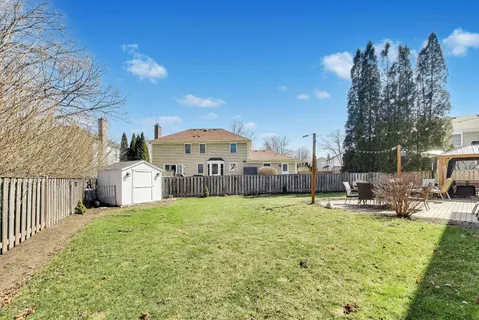 a view of a house with patio next to a yard