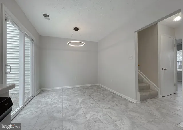 an empty room with a fireplace and a window