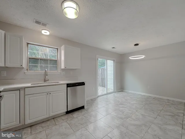 a kitchen with sink and window