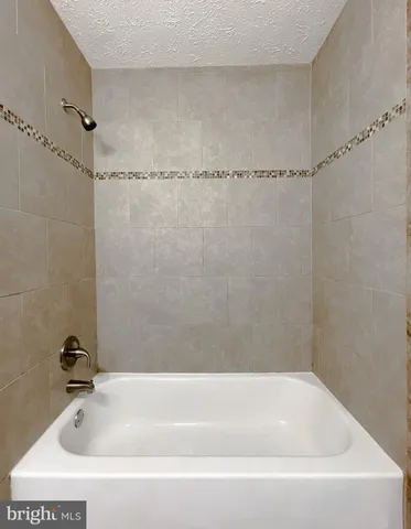 a bathroom with a shower and a bathtub
