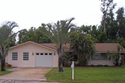 18056 Cypress Point Road Fort Myers, FL 33967 - Photo 3 of 8 a view of a house with a yard and a garden
