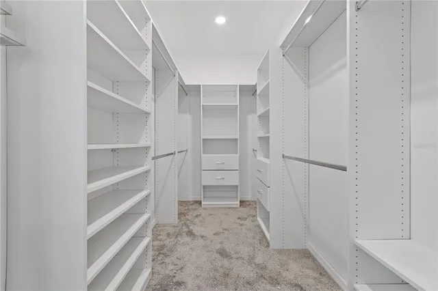 a view of walk in closet with empty racks