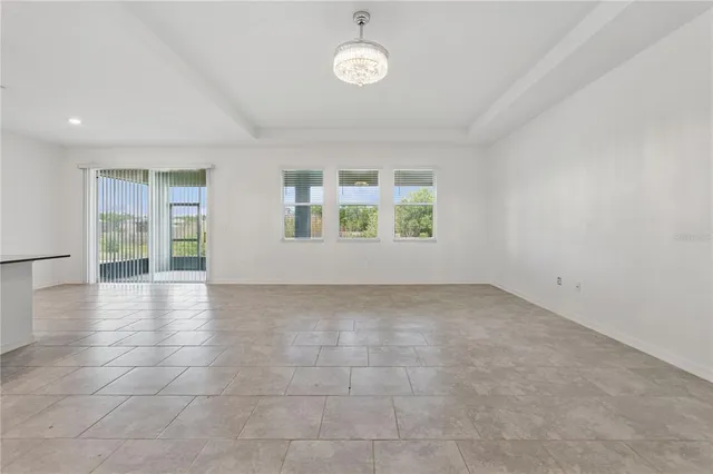 an empty room with windows and entrance