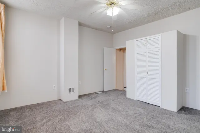 an empty room with closet area